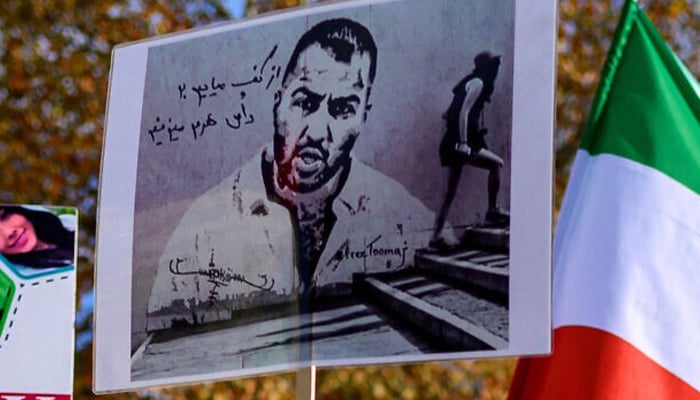 People hold placards bearing portraits of Iranian rapper Toomaj Salehi during a rally in support of Iranian women in Istanbul, on November 26, 2022. — AFP