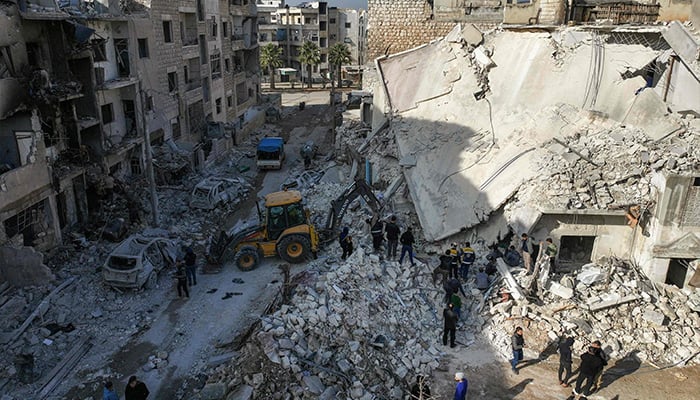 Syrian rescuers known as the White Helmets searching building rubble for survivors at the site of a reported airstrike on a neighbourhood in Syria´s rebel-held northern city of Idlib on December 2, 2024.  — AFP