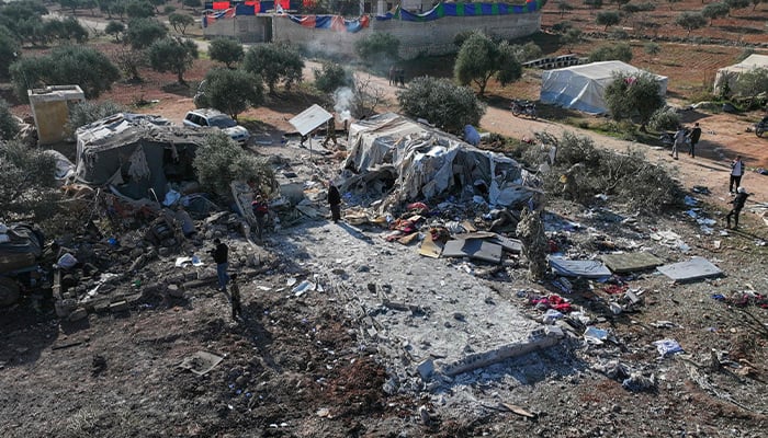 People inspecting the damage after a reported airstrike on makeshift camp for displaced Syrians near the town of Maarrat Misrin in the northern part of the Idlib governorate on December 2, 2024. — AFP