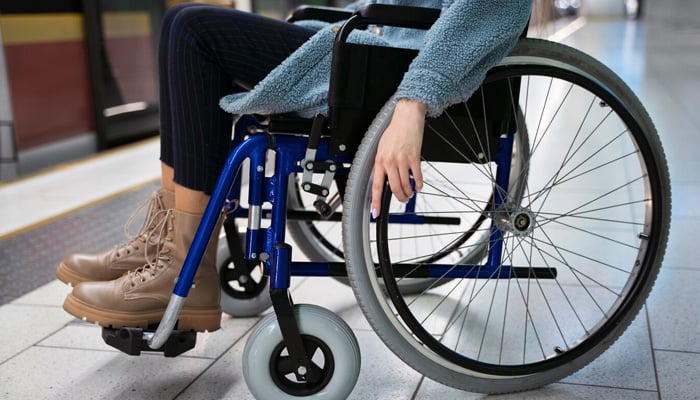 Representational image of a woman in a wheelchair at a subway station. — Freepik