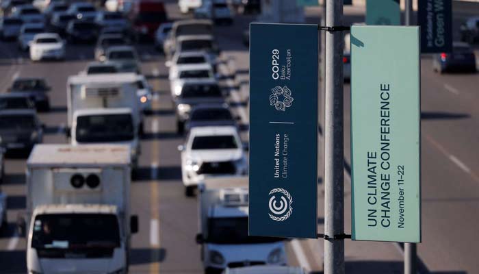 Cars drive as a billboard with the logo of the COP29 United Nations climate change conference is seen, in Baku, Azerbaijan November 22, 2024. — Reuters