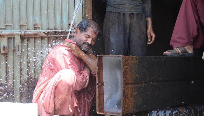 A man taking a bath to beat the heat in Hyderabad, in May, 2024. — INP/File