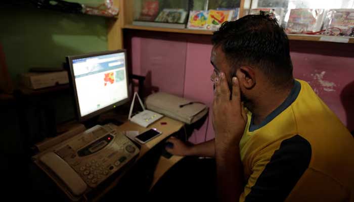 A man explores social media on a computer at an internet club in Islamabad, August 11, 2016. — Reuters