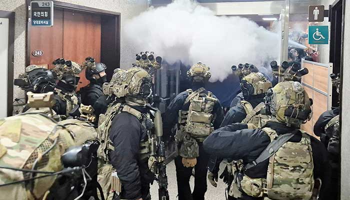 Soldiers advance to the main building of the National Assembly after South Korean President Yoon Suk Yeol declared martial law in Seoul, South Korea, December 3, 2024. — Reuters