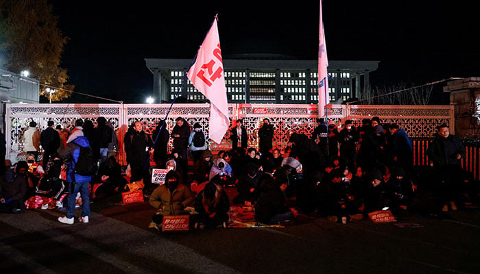 People gather by the gate of the National Assembly, after South Korean President Yoon Suk Yeol declared martial law, in Seoul, South Korea, December 4, 2024. — Reuters