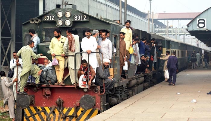 Employees of Railway workshop traveling on railway Engine as going Pakistan Railways Locomotive Shed in Lahore. — Online/File