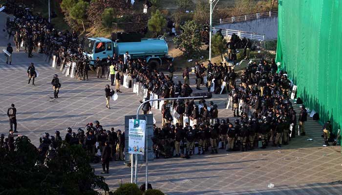 A view of large number of police personal stand near container at D chowk due to PTI protest in twin cites on November 25, 2024. — INP