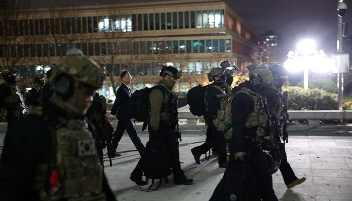 Military forces walk outside the National Assembly, after South Korean President Yoon Suk Yeol declared martial law, in Seoul, South Korea, December 4, 2024. — Reuters