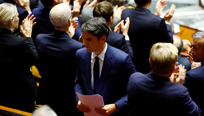 Former French Prime Minister Gabriel Attal, member of parliament and president of the Ensemble pour la Republique (EPR) parliamentary group, is applauded by members of parliament after he delivered a speech during a debate on two motions of no-confidence against the French government, tabled by the alliance of left-wing parties the Nouveau Front Populaire (New Popular Front - NFP) and the far-right Rassemblement National party, after the use by French government of the article 49.3, a special clause in the French Constitution, to push the budget bill through the National Assembly without a vote by lawmakers, at the National Assembly in Paris, France, December 4, 2024. — Reuters