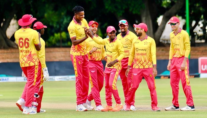 Zimbabwes Blessing Muzarabani celebrates with teammates after taking a wicket during third T20I against Pakistan on December 5, 2024. - X/ZimCricketv