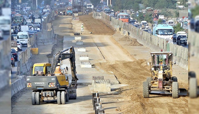 Heavy machinery being used during the development work on University Road in Karachi on September 25, 2024. — APP