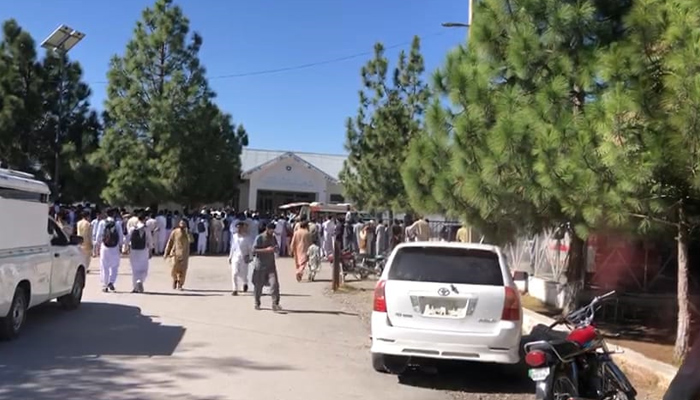 A crowd is gathered outside a health facility in District Kurram. — Reporter/File