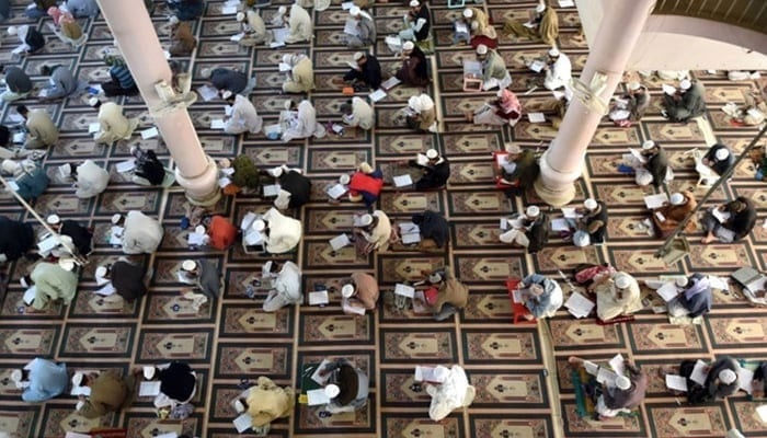 This representational image shows students taking mid-term exams at a seminary in Karachi. — AFP/File