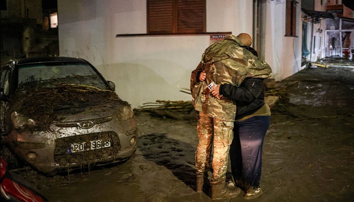 Sofia Kanelli and Nikolaos Savas embrace after torrential rains flooded their home and destroyed their cars in the popular Greek tourist resort as Storm Bora pounded the country for a second day causing floods in Ialysos, Island of Rhodes, Greece December 1, 2024. — Reuters