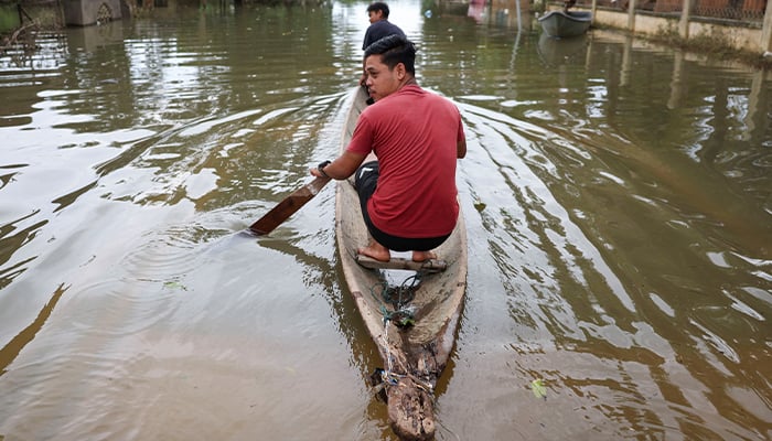 People ride a boat in a flooded area in Rantau Panjang, Malaysia December 3, 2024. — Reuters