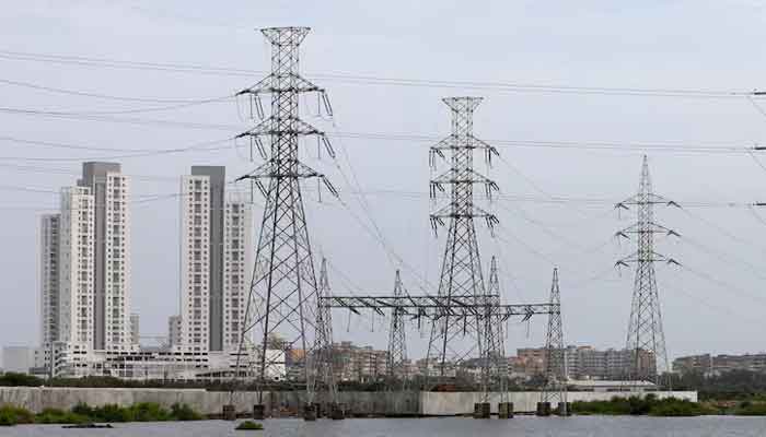 Power transmission towers are pictured in Karachi on July 26, 2022. — Reuters