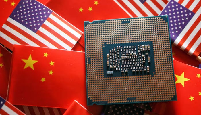 A central processing unit (CPU) semiconductor chip is displayed among flags of China and US, in this illustration picture taken February 17, 2023. — Reuters