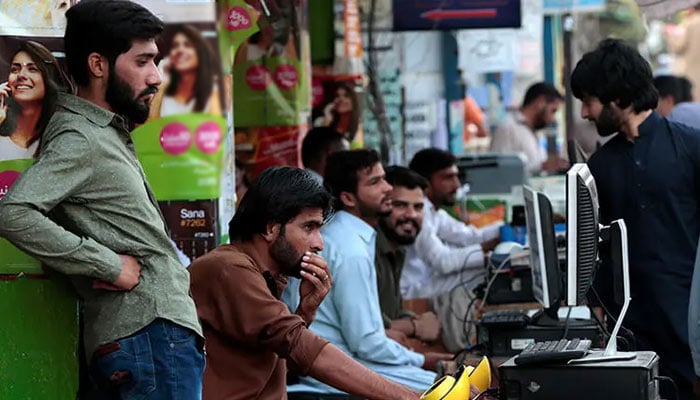 A representational image of youngsters using internet at a roadside setup in this undated image. — Reuters