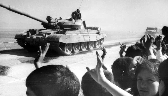 Afghan civilians bid farewell to departing Soviet troops in Shindand, Afghanistan on October 1986. — Reuters