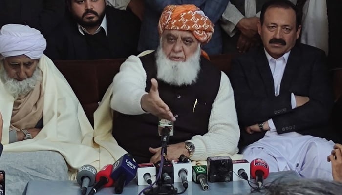 Jamiat Ulema-e-Islam-Fazl Chief Maulana Fazlur Rehman (centre) addresses the press conference in Charsadda, Khyber Pakhtunkhwa, on December 9, 2024. — X/@juipakofficial