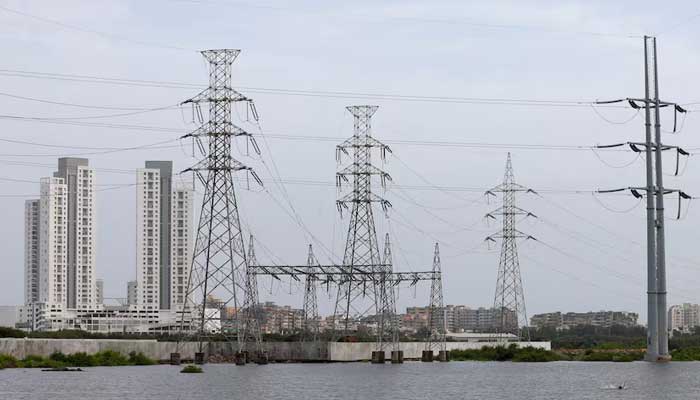 Power transmission towers are pictured in Karachi on July 26, 2022. — Reuters