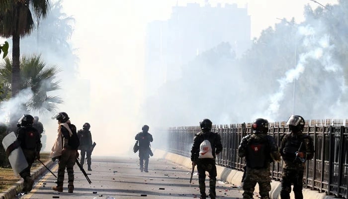 A view of the security personnel firing tear gas shell amidst clash with PTI protesters in Islamabad on November 26, 2024. — INP