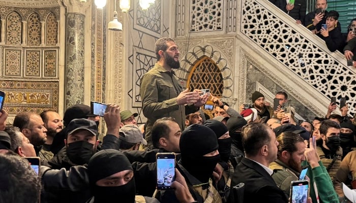 Top rebel commander Abu Mohammed al-Golani speaks to a crowd at Ummayad Mosque in Damascus, Syria, on December 8, 2024. —Reuters