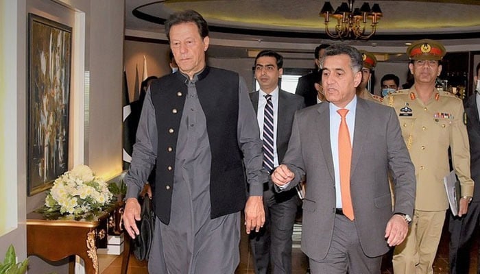 Then-prime minister Imran Khan (left) walks along side then-ISI chief Lt Gen Faiz Hamid. — PMs Office/File