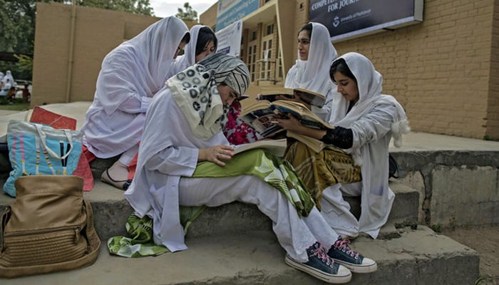 Psychology students study outside the Competence and Trauma Centre for Journalists inside a universitys psychology department in Peshawar on November 24, 2014. — Reuters