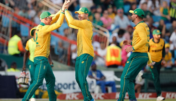 South Africas Rassie van der Dussen (L) celebrates with teammates after catching a ball dismissing Pakistans captain Mohammad Rizwan (useen) during the second T20 international cricket match between South Africa and Pakistan at Supersport Park in Centurion on December 13, 2024. — AFP