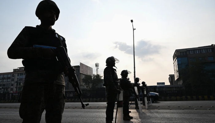 Paramilitary soldiers stand guard at a blocked road leading towards the Red Zone area ahead of a protest rally by the PTI in Islamabad on November 24, 2024. —AFP