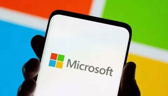 Smartphone is seen in front of Microsoft logo displayed in this illustration taken July 26, 2021. — Reuters