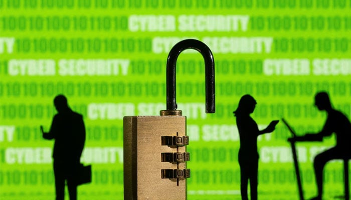 Representational image of a screen bearing text cyber security seen in background of toy humans and a padlock. — Reuters