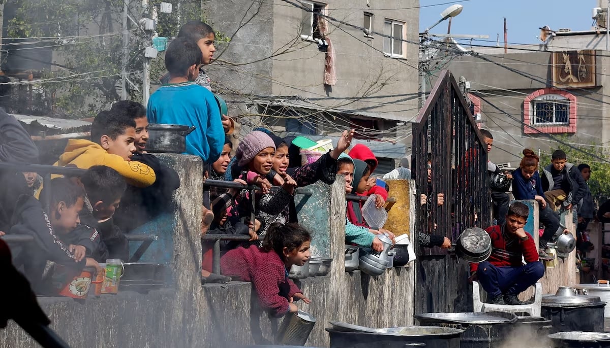 Palestinian children wait to receive food cooked by a charity kitchen amid shortages of food supplies, as the ongoing conflict between Israel and the Palestinian group Hamas continues, in Rafah, in the southern Gaza Strip, February 20, 2024. — Reuters