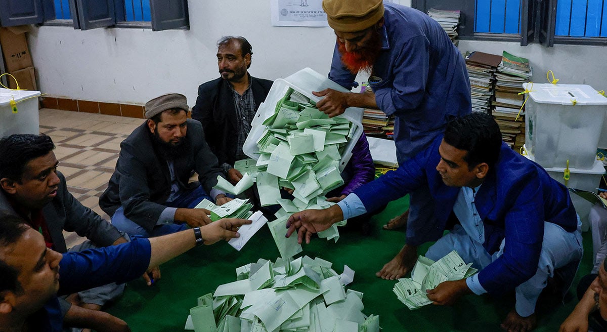 Polling officers count ballot papers during the general election in Karachi on February 8, 2024. — Reuters