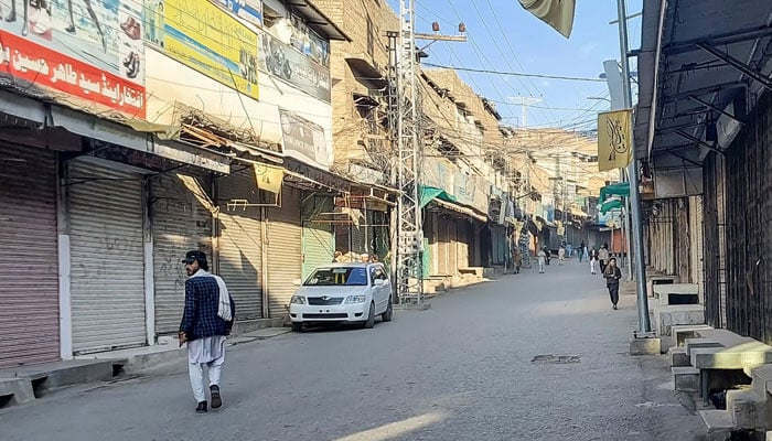 Men walk past a market closed by traders during a strike against attacks in Kurram district in Parachinar, the mountainous Khyber Pakhtunkhwa province, on November 22, 2024. — AFP