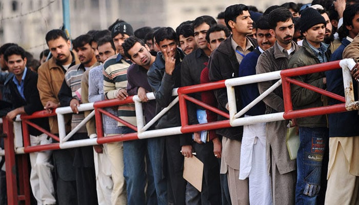 Pakistani youth wait for their turn for a Capital Development Authority (CDA) job entry test in this undated image. — AFP