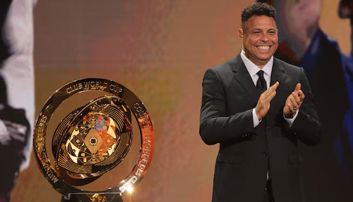 Brazilian former soccer player Ronaldo Nazario reacts next to the FIFA Club World Cup trophy during the Club Word Cup draw at Telemundo Studios in Miami, Florida, US on December 5, 2024. — Reuters