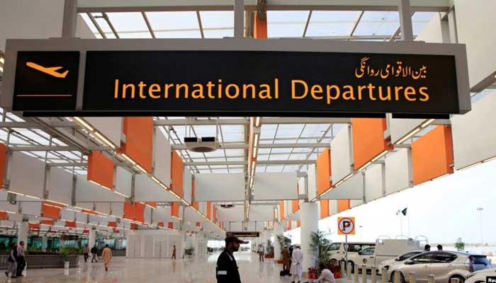 A worker walks at the departure area of the Islamabad International Airport. — Reuters/File