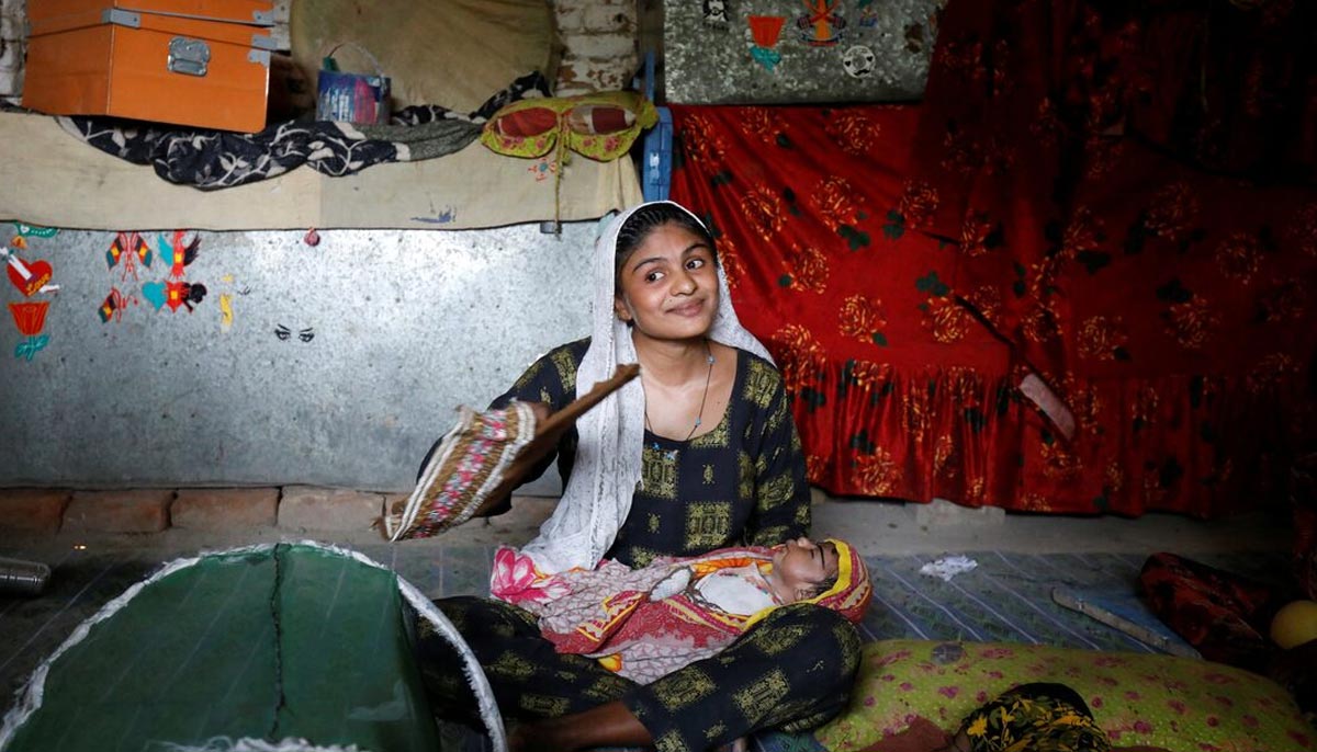 Farmer Waderi, 17, fans her one-month-old son Amar Kumar during a heatwave, at home, on the outskirts of Jacobabad on May 17, 2022. — Reuters