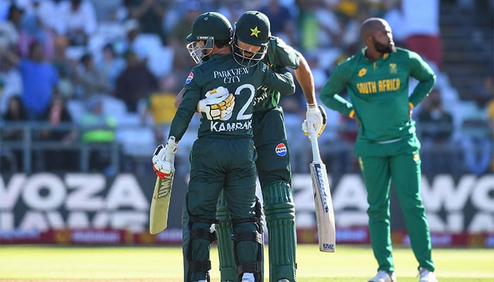 Pakistans Kamran Ghulam (L) celebrates after scoring a half century with Pakistans Irfan Khan (C) during the second ODI match against South Africa at Newlands Cricket Ground, Cape Town on December 19, 2024. — AFP