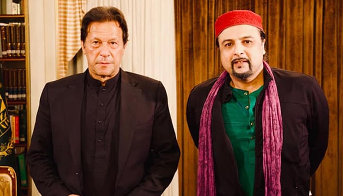 Famous musician and PTI activist Salman Ahmed (right) poses for a picture with PTI founder Imran Khan. — Facebook/@sufisal