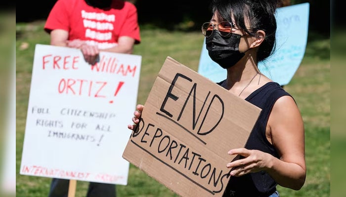 Protesters holding signs take part in a rally to demand the end of deportations in US immigration policy, at Silver Lake Reservoir in Los Angeles, California, US on March 6, 2021. — Reuters