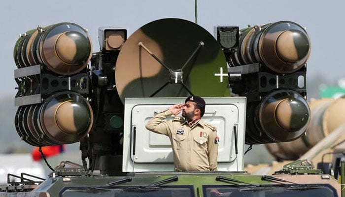 Pakistani Army soldier salutes while standing on an air defence missile system during Pakistan Day military parade in Islamabad, Pakistan, March 23, 2022. —