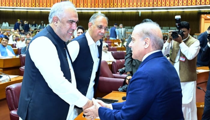 Prime Minister Shehbaz Sharif shakes hands with former speaker of the National Assembly and PTI leader Asad Qaiser (left), during a session of the National Assembly in Islamabad on June 26, 2024. —PMO