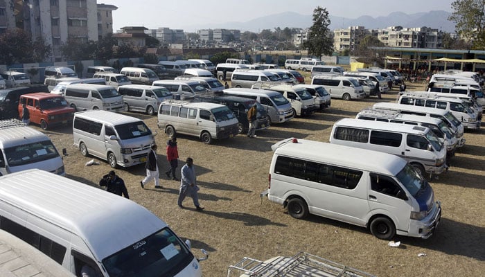 Vehicles stand in the grounds of a school, in Islamabad on February 7, 2024. — Online