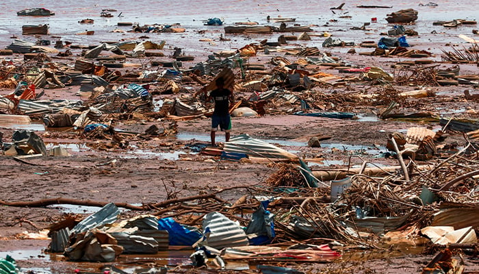 A boy carries a roofing sheet on the beach in the aftermath of Cyclone Chido, in Passamainty, Mayotte, France December 20, 2024. — Reuters