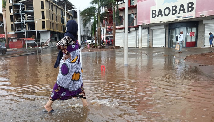 A person walks in a flooded street after heavy rains in the aftermath of Cyclone Chido, in Mamoudzou, Mayotte, France, December 19, 2024. — Reuters