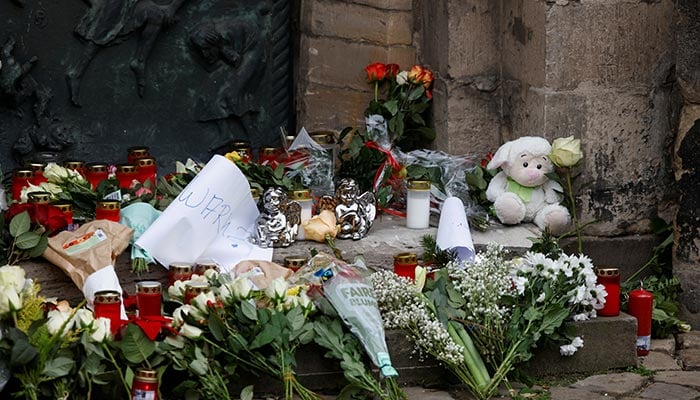 Floral tributes are left by a church near the site where a car drove into a crowd at a Magdeburg Christmas market in Magdeburg, Germany December 21, 2024. — Reuters