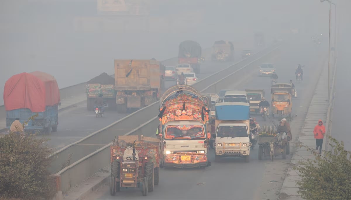 Vehicles move amid dense smog in Lahore, November 24, 2021. — Reuters